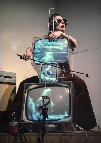 Charlotte Moorman performs Nam June Paik’s TV Cello wearing TV Glasses, New York, 1971. Photo: Takahiko iimura.